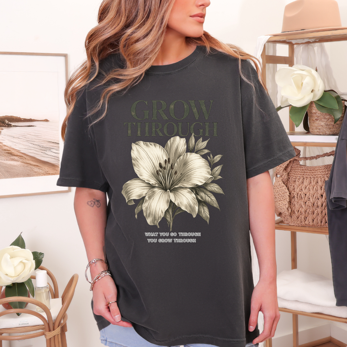 Person wearing a black t-shirt with a floral design and text in a home setting