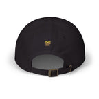 Black cap with a gold yellow' on back flavored and blessed  a white background,highly favored and blessed 