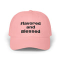 Pink cap with 'Flavored and Blessed' text on a white background