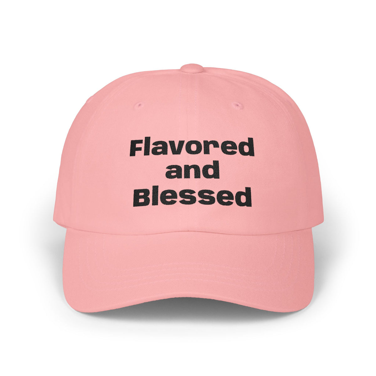 Pink cap with 'Flavored and Blessed' text on a white background