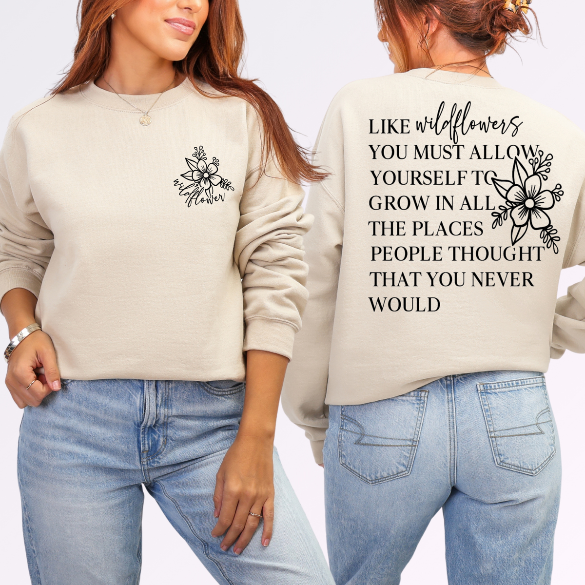 Person wearing a beige sweatshirt with a floral design on the front and text on the back, standing against a light gray background.